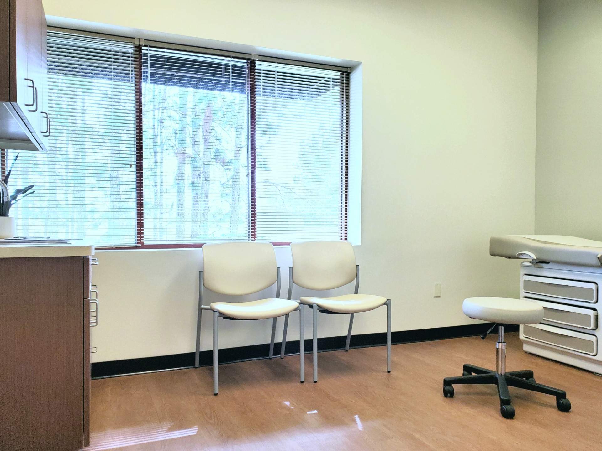 Photo of Gastroenterology of Greater Orlando Empty Patient Room with Two Patient Chairs and One Doctor Rolling chair at Lake Mary Location